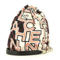 Chanel shoulder bag in pink, white and black logo canvas